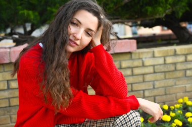 Kırmızı kazaklı genç bir kızın portresi.