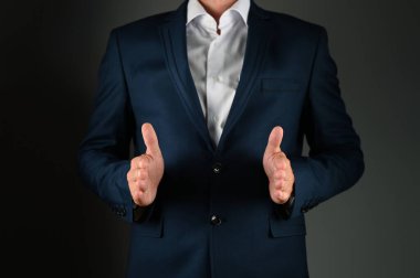 Takım elbiseli bir adam bedenini elleriyle gösterir. Yüksek kalite fotoğraf