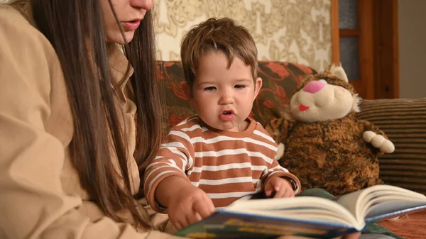 mom and child read a book before bedtime child. High quality photo