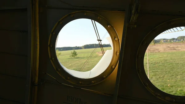 Round airplane windows. Overlooking the field. High quality photo