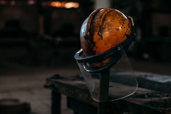 막대기에는 공장에 오래 된 오렌지 건설 헬멧 — 스톡 사진