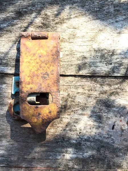 Old wooden chest with rusty padlock.