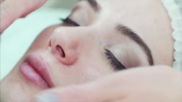 Extreme close portrait of attractive woman relaxing on cosmetic procedure. — Stock Video