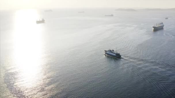 Vista aérea del ferry flotando a lo largo del estrecho, y otros barcos en el fondo — Vídeo de stock