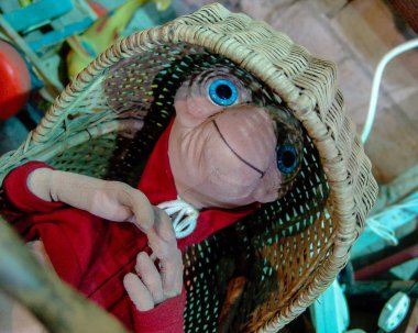 ET stuffed toy from 80's movie, laying in straw crib. clipart