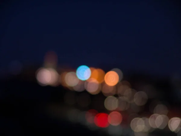 Night city lights bokeh of defocused vivid colorful circles of l — Stock Photo, Image