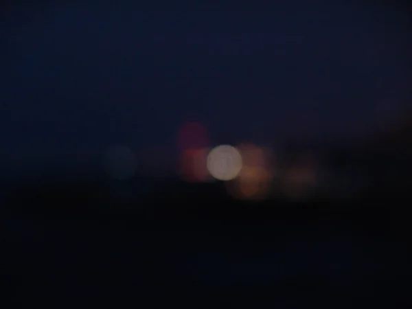 Night city lights bokeh of defocused vivid colorful circles of l — Stock Photo, Image