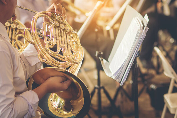 musicians playing french horn practice for show in music band.