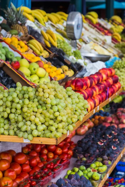 Fresh fruit piled high on shelves on a market stall in Rovinj, Croatia.