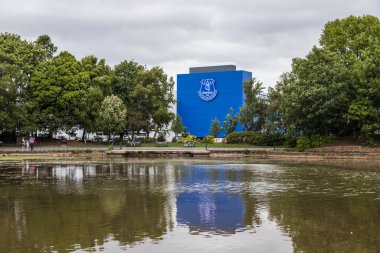 The home of Everton FC (Goodison Park) pictured reflecting in a lake within Stanley Park (England) in June 2020. clipart