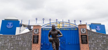 Dixie Dean statue in front of the Wall of Fame outside the home of Everton FC in England seen in June 2020. clipart