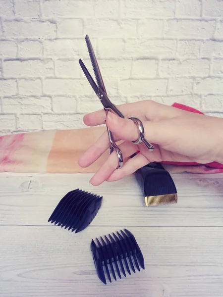 Different hairdressing tools lie on the table at the master in a beauty salon. Beautiful interior in bright colors.