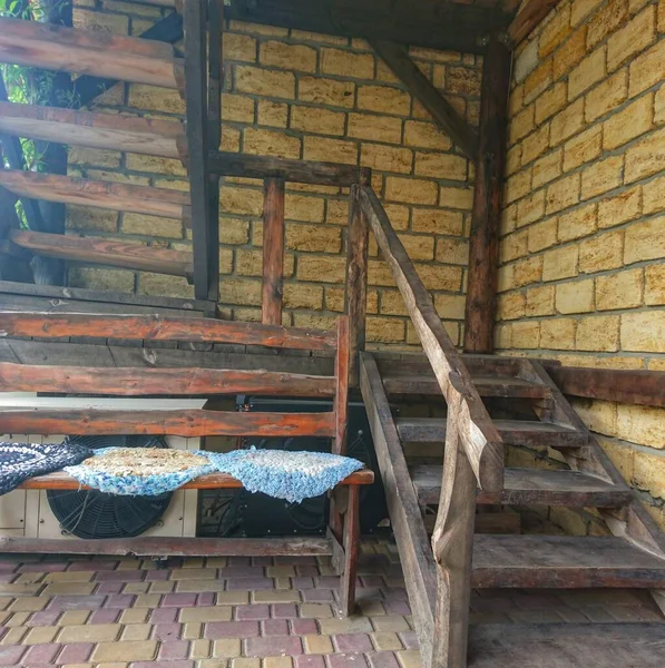 Vintage steps and railings made of wood in a brick house