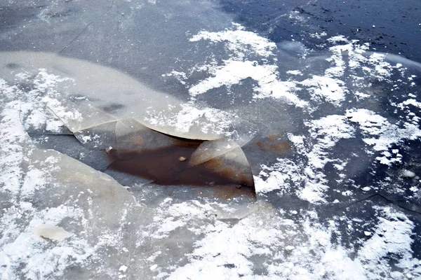 Parkta kışın nehir üzerinde kırık karla kaplı buz bir görünüm ile yatay fotoğraf. Rusya, Pskov. Renkler beyaz, gri, kahverengi, mavi