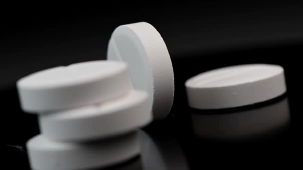 White pill rotate on a black background, Macro shot — Stock Video