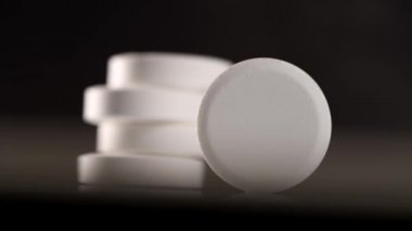 Beyaz hap siyah bir arka planda döndürmek, makro shot