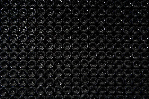 Big stock of wine bottles laying in wine cellar, Bordeaux winery, France