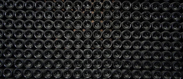 Big stock of wine bottles laying in wine cellar, Bordeaux winery, France