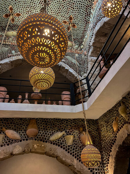 Visit the Guellala pottery shop in Djerba, Tunisia to see beautiful handcrafted pots displayed under a sunny sky, perfect for those seeking local artistry and culture.