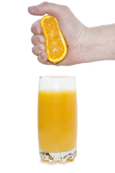 Man squeezes orange in a glass — Stock Photo, Image