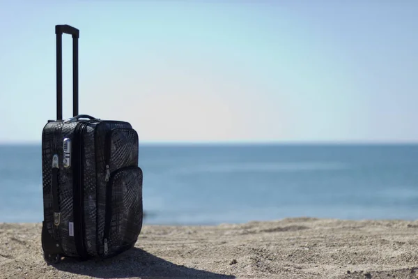 Sahilde deniz kenarında turistik bavul