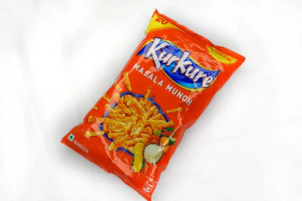 Jhargram, West Bengal, India; August 1, 2025: Famous Indian snacks brand Kurkure Masala Munch on white background. Indian tea snacks concepts.