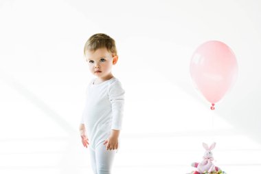 Beyaz oyuncak tavşan yakın ayakta sevimli çocuk pembe hava balon