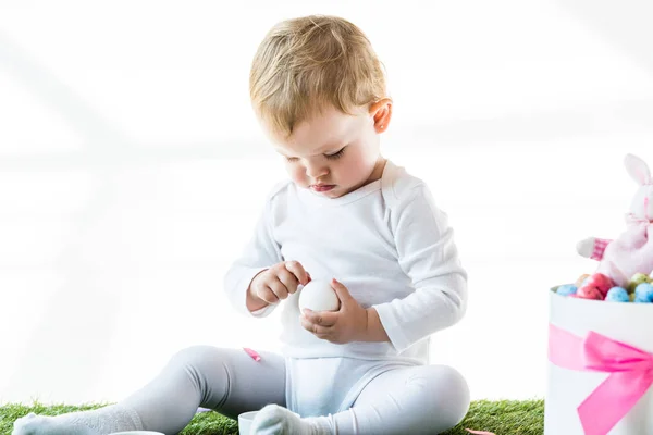 Adorable Niño Sosteniendo Huevo Gallina Blanca Mientras Está Sentado Cerca — Foto de Stock