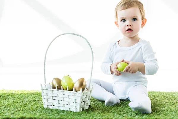 Cute Blonde Baby Holding Yellow Chicken Egg While Sitting Green — Stock Photo, Image