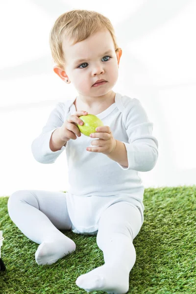 Cute Dreamy Baby Holding Yellow Chicken Egg Looking Away Isolated — Stock Photo, Image