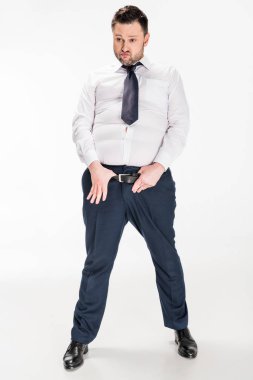 overweight man in tight formal wear with hands on belt posing on white clipart