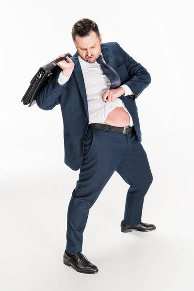 overweight businessman in tight formal wear with briefcase on white