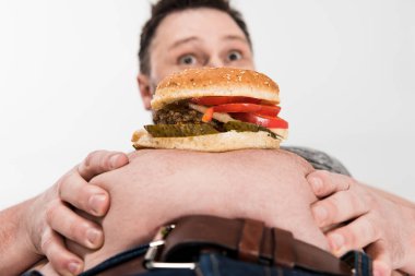 beyaz izole göbek üzerinde burger ile sürpriz kilolu adam