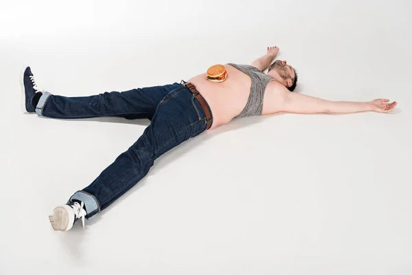 Overweight Man Burger Belly Lying Outstretched Hands White — Stock Photo, Image