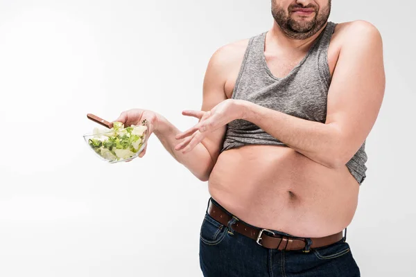 Cropped View Overweight Man Holding Bowl Salad Disgust Isolated White — Stock Photo, Image