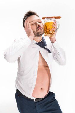 overweight man holding glass of beer with sausage and posing with eyes closed isolated on white clipart