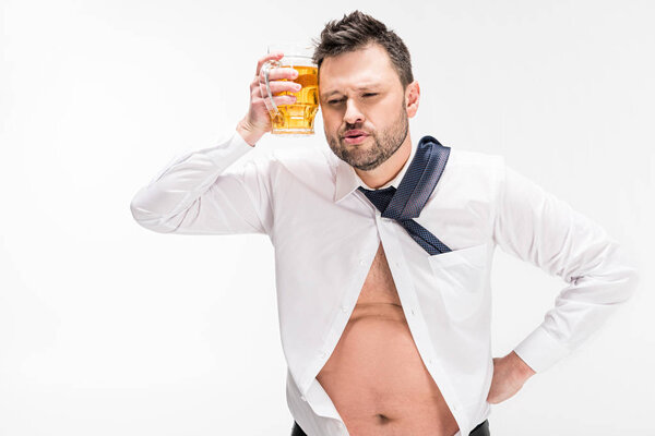 overweight man holding glass of beer near face isolated on white