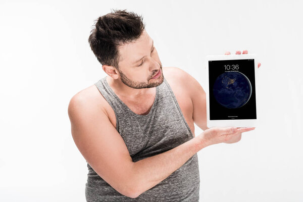 overweight man showing digital tablet with apple home screen isolated on white