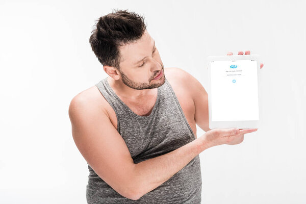 overweight man showing digital tablet with skype app on screen isolated on white