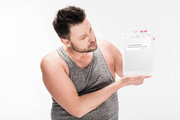 overweight man showing digital tablet with vkontakte app on screen isolated on white