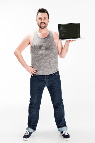 smiling overweight man looking at camera and presenting laptop with microsoft windows software on screen isolated on white