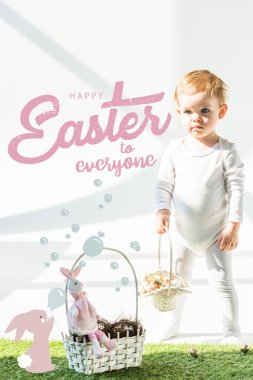 cute babystanding with wicker basket on green grass near golden quail eggs, happy Easter to everyone lettering and rabbit blowing soap bubbles illustration clipart