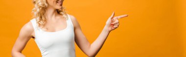 panoramic shot of blonde woman pointing with finger on orange  clipart