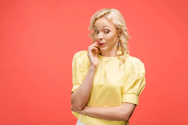 Confused Blonde Woman Touching Face While Standing Red — Stock Photo, Image