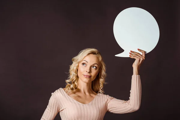 attractive blonde woman holding speech bubble isolated on black