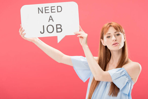 redhead girl holding speech bubble with inscription need a job isolated on pink