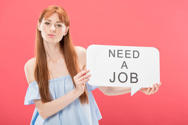 redhead girl holding speech bubble with inscription need a job isolated on pink