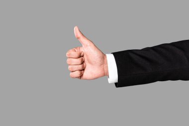 cropped view of businessman showing thumb up isolated on grey clipart