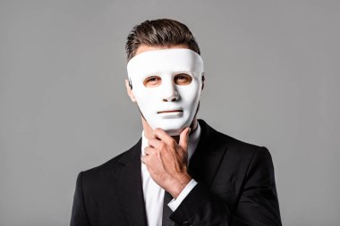 mysterious businessman in white mask isolated on grey clipart