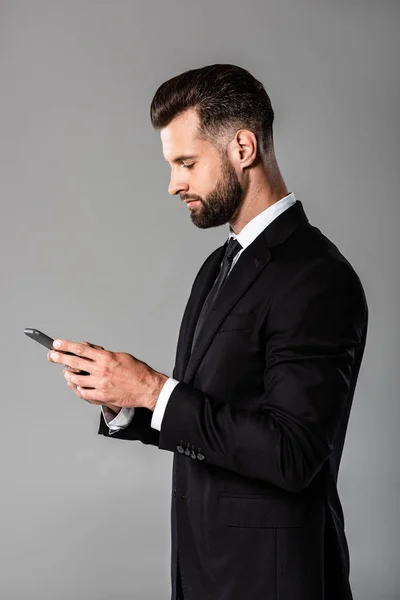 Side View Handsome Businessman Black Suit Using Smartphone Isolated Grey — Stock Photo, Image